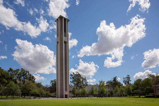 Bell Tower in front of blue sky with clouds (c) UCR/Stan Lim