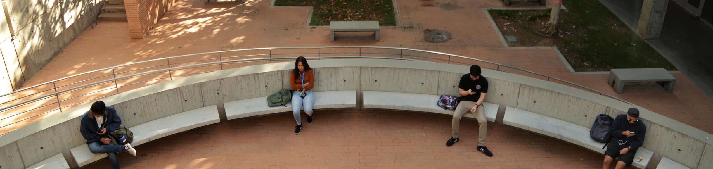 Students sitting on Bourns Building's semi-circle of benches before class